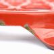 Vintage red enameled cast iron trivet