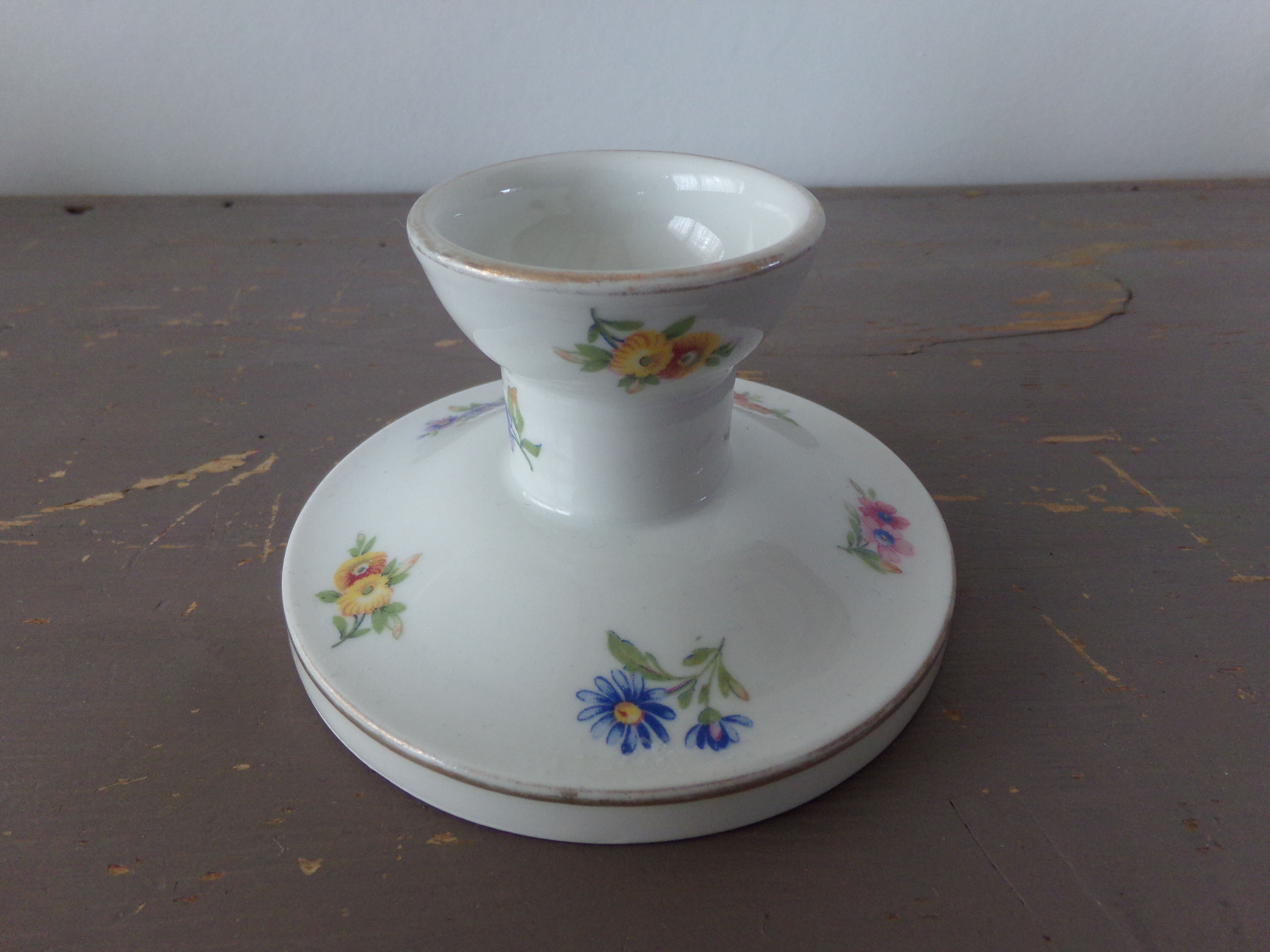 Old candle holder in flowered porcelain