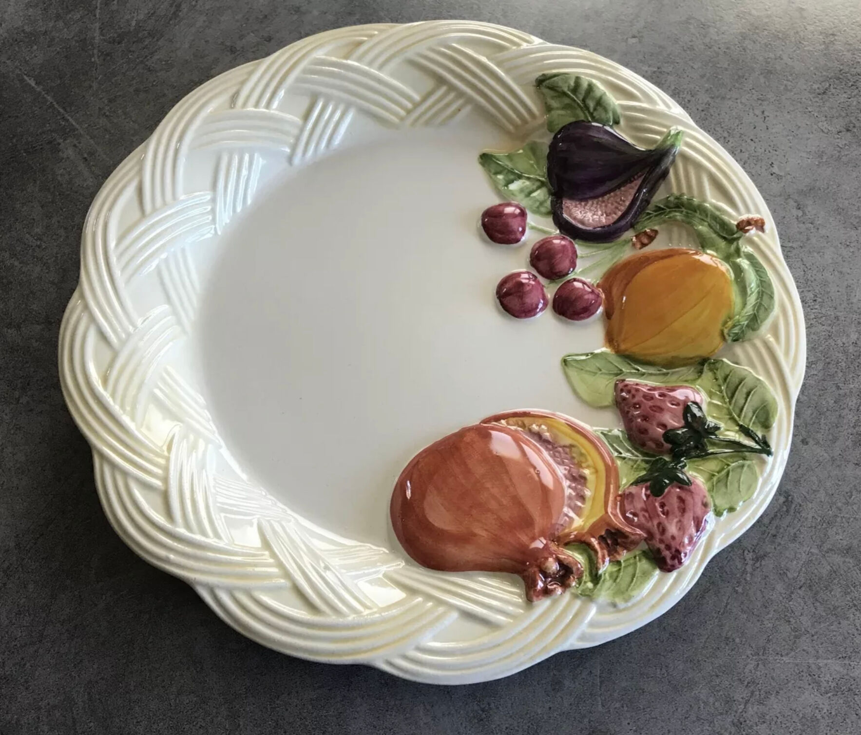 Vintage plate in ceramic enamelled decoration of fruits in relief