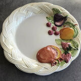 Vintage plate in ceramic enamelled decoration of fruits in relief