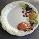 Vintage plate in ceramic enamelled decoration of fruits in relief