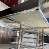 Coffee table with chrome base and mirrored glass top, vintage solar flare decor