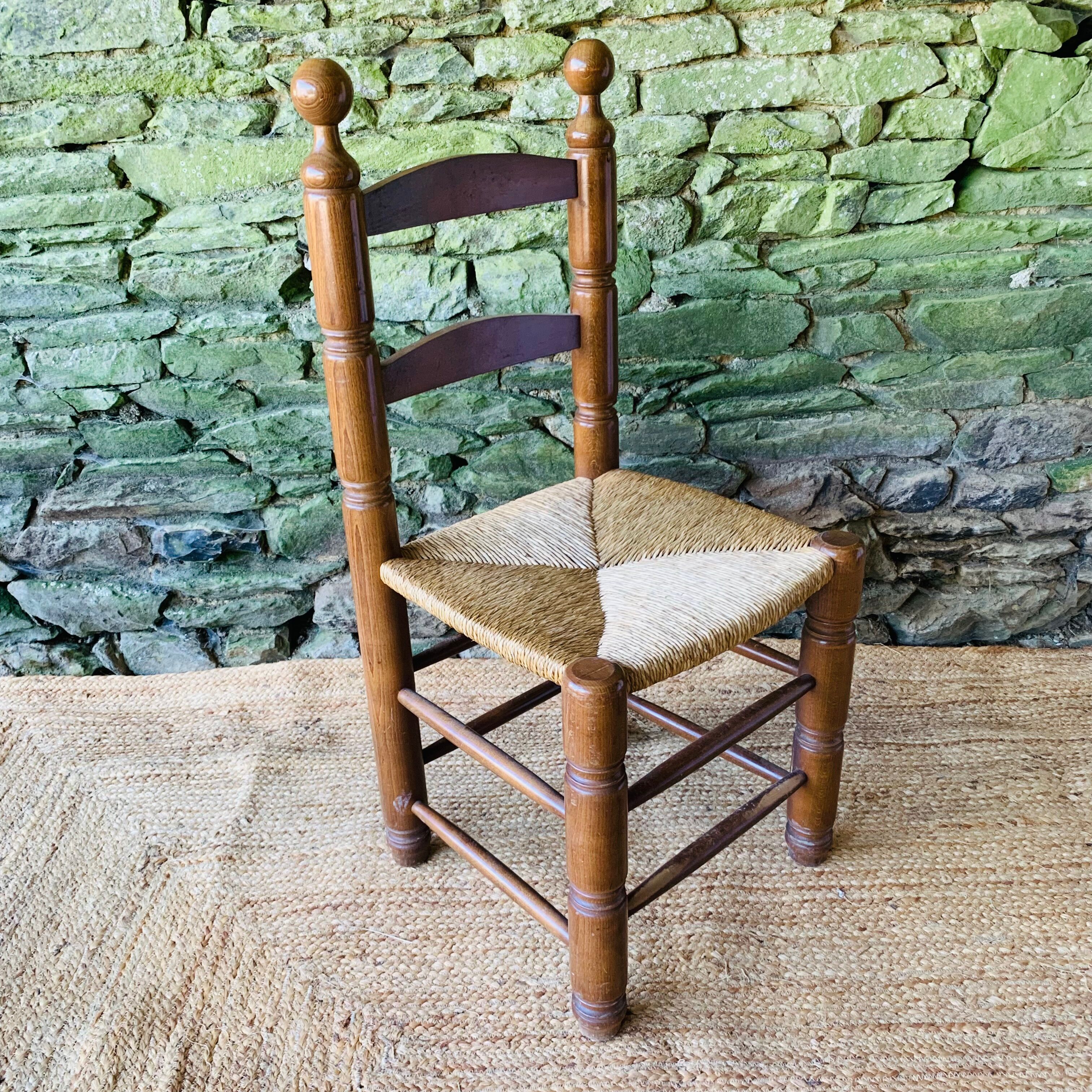 Set of 4 solid wood chairs with straw seats.