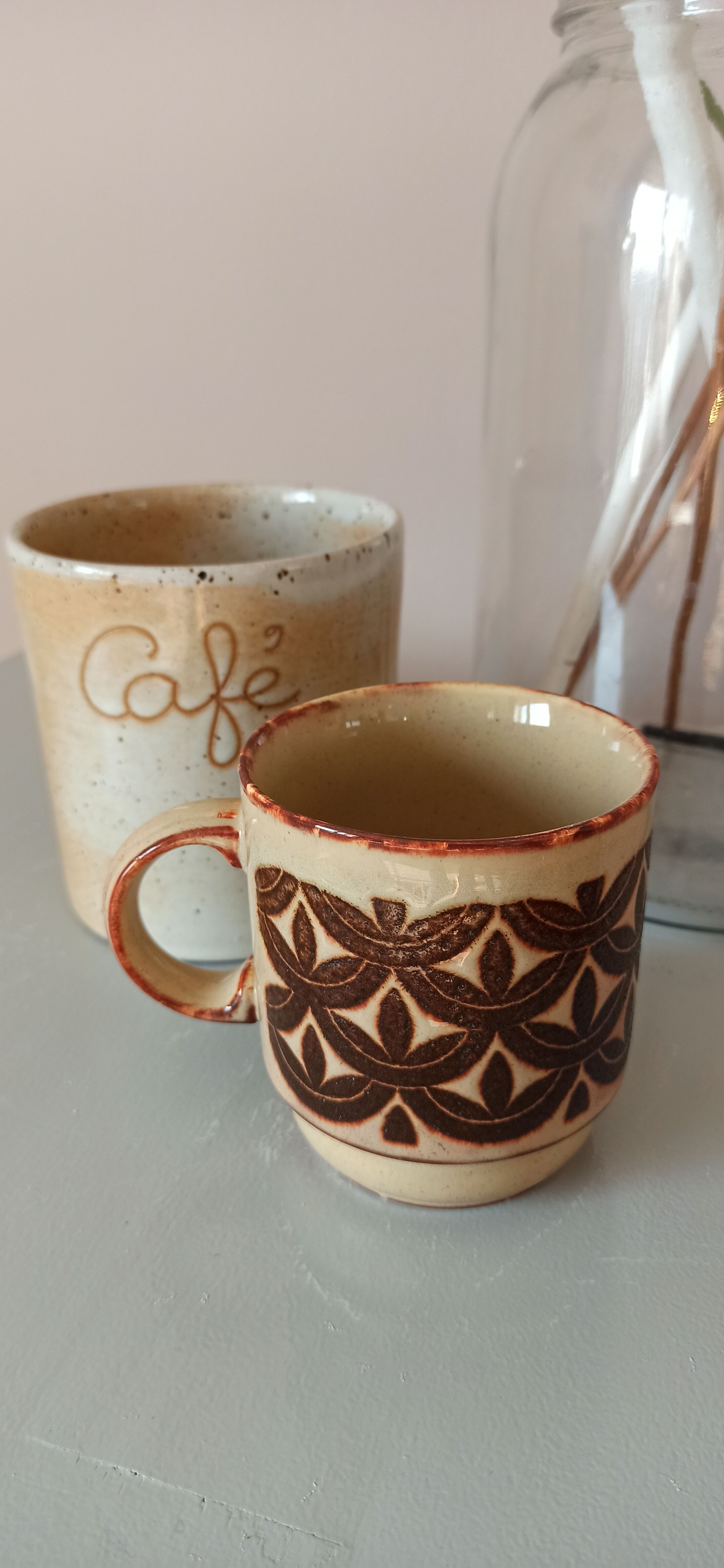 Coffee pot and mug cup in sandstone