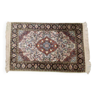 Handmade Persian carpet in wool and silk.