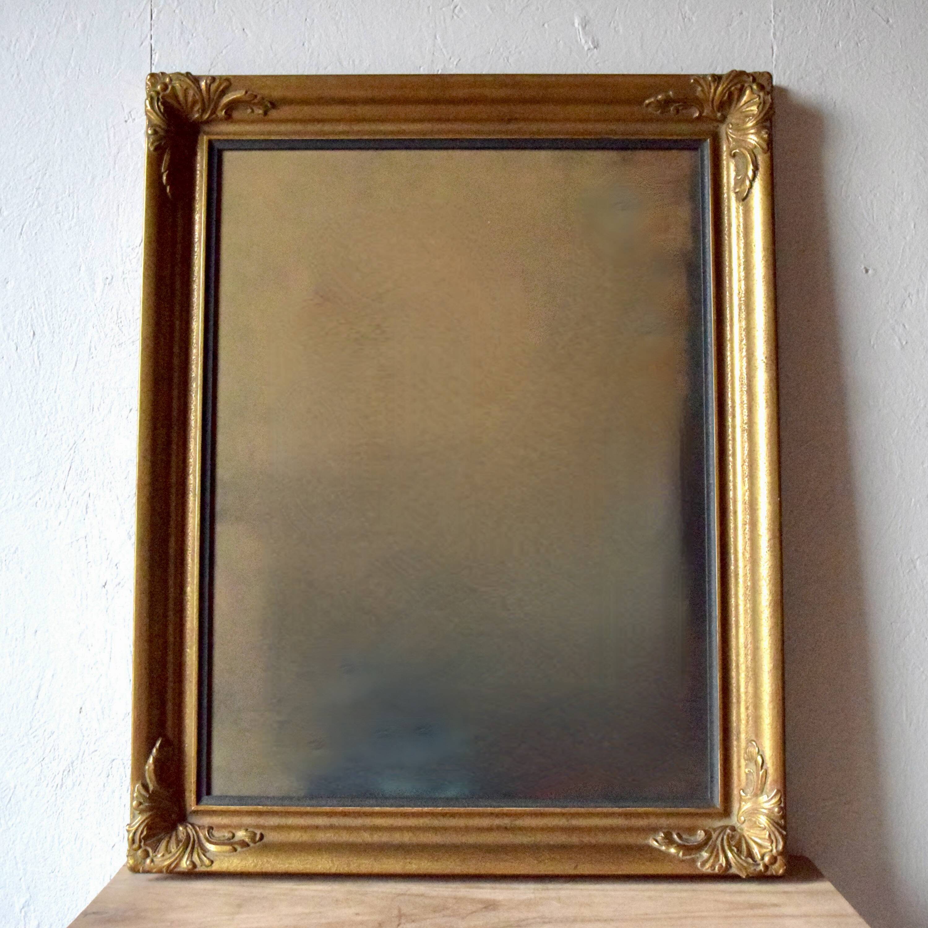 Old large wall frame in gilded carved wood