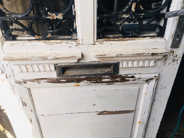 Old door with wrought iron grille