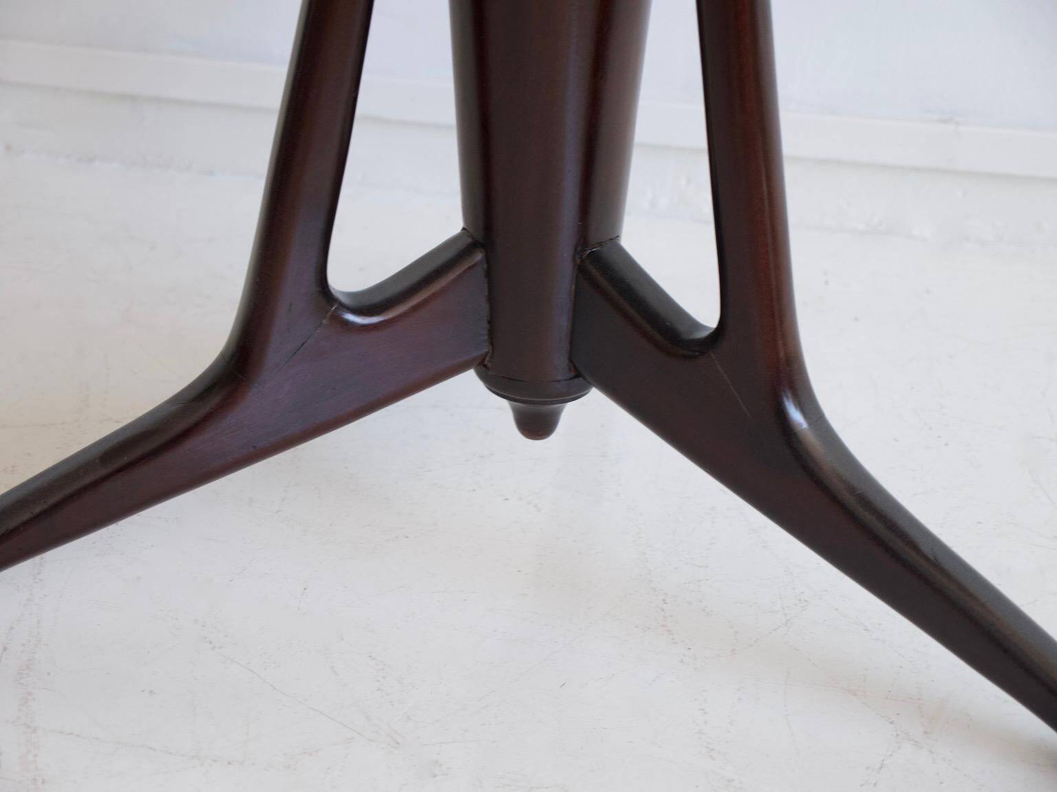 Mid-century modern round dining table in marble and ebony wood.
