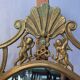 Oval mirror in gilded brass, figures of cherubs and moldings
