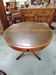 Round Regency dining table in mahogany and green leather with extensions - 20th century