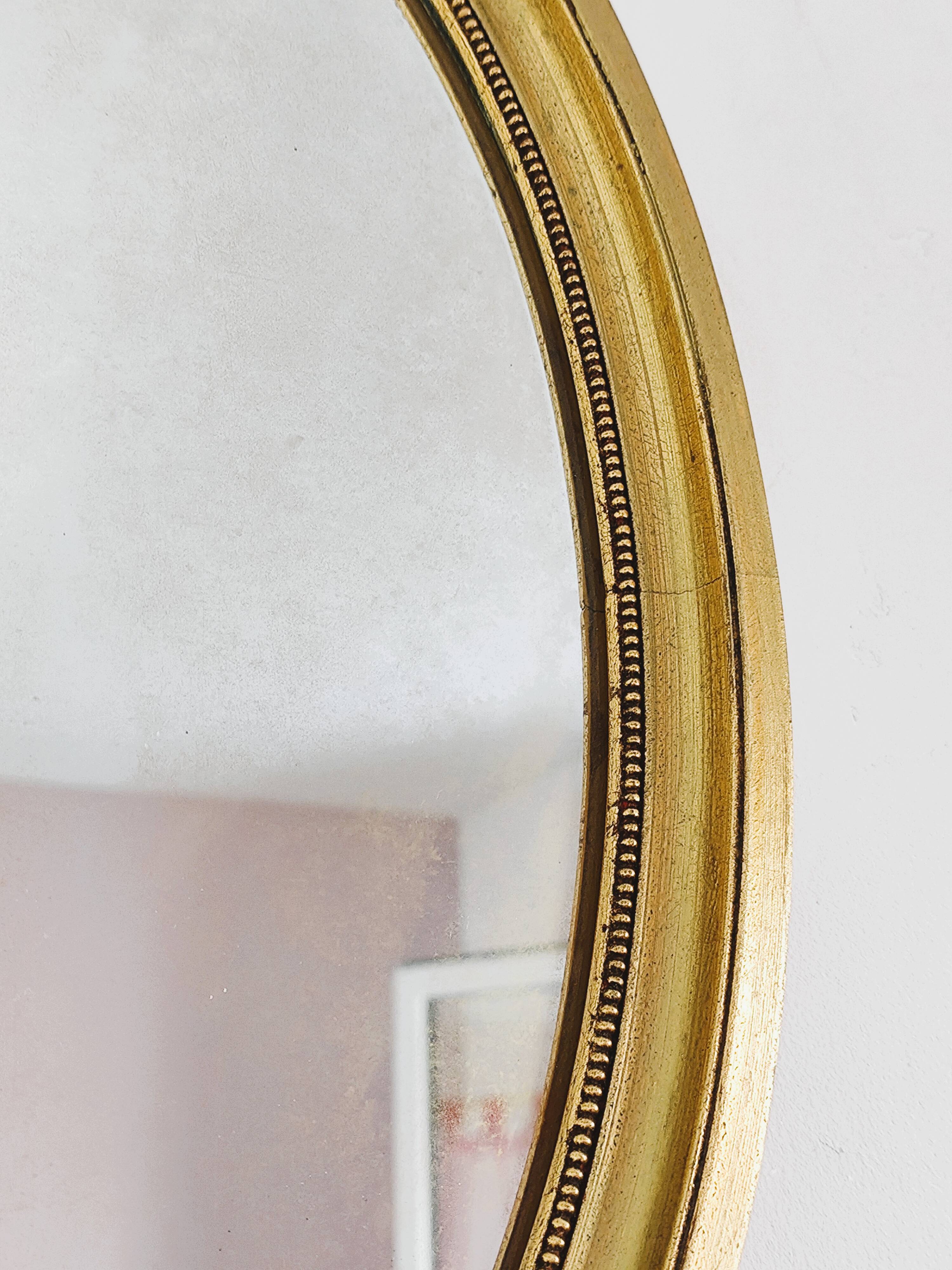 Antique gold oval mirror