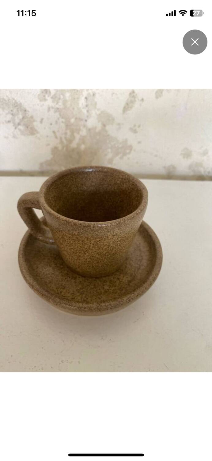 Set of stoneware coffee cups with saucers.