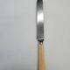 Set of 4 dessert knives with rounded blades and smooth ivory resin handles.