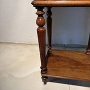 Antique wooden bedside table with turned legs.