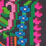 Handwoven colorful Romanian carpet, green and black background with gorgeous colorful flowers