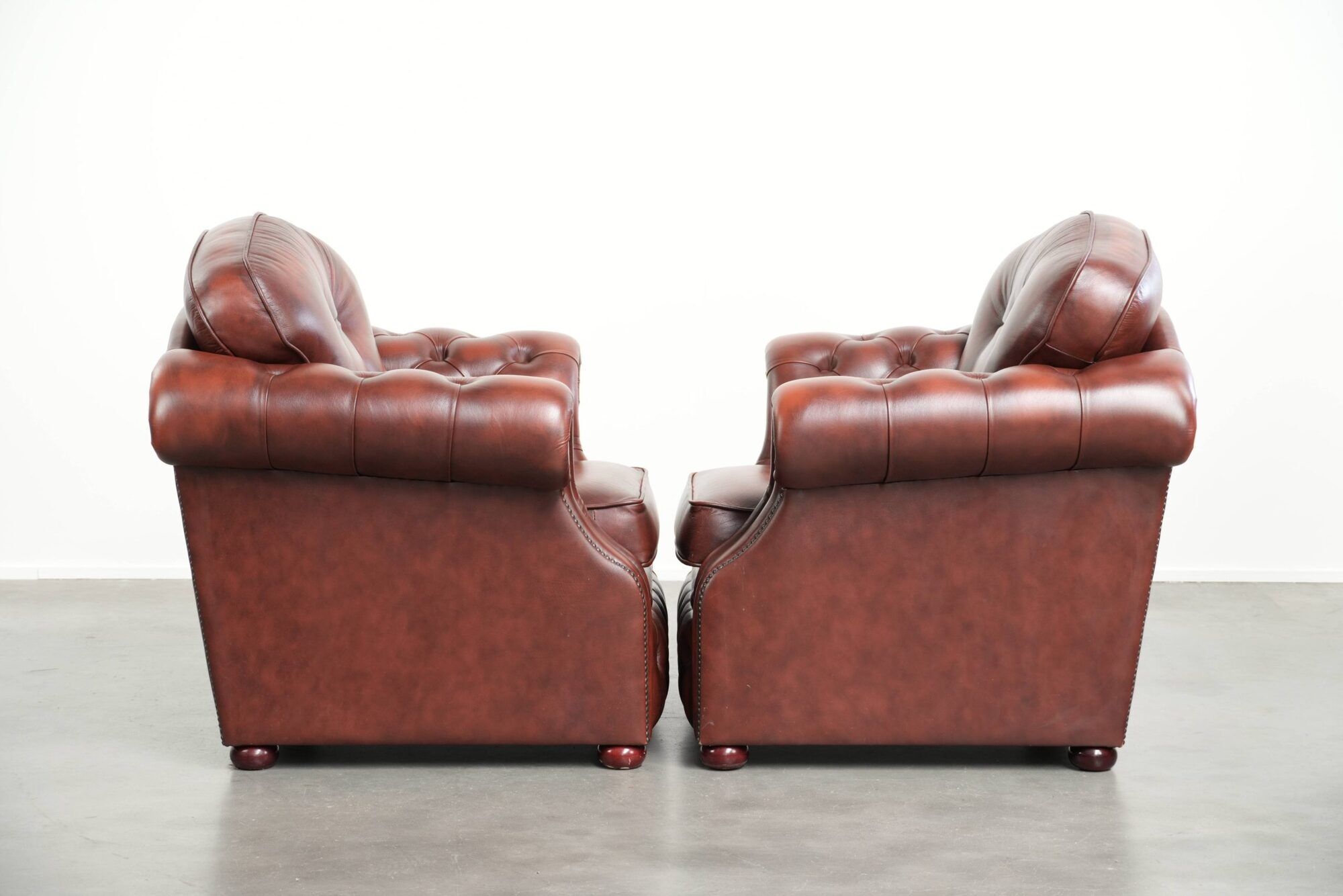 Vintage set of 2 cowhide leather Chesterfield armchairs in a brown colour