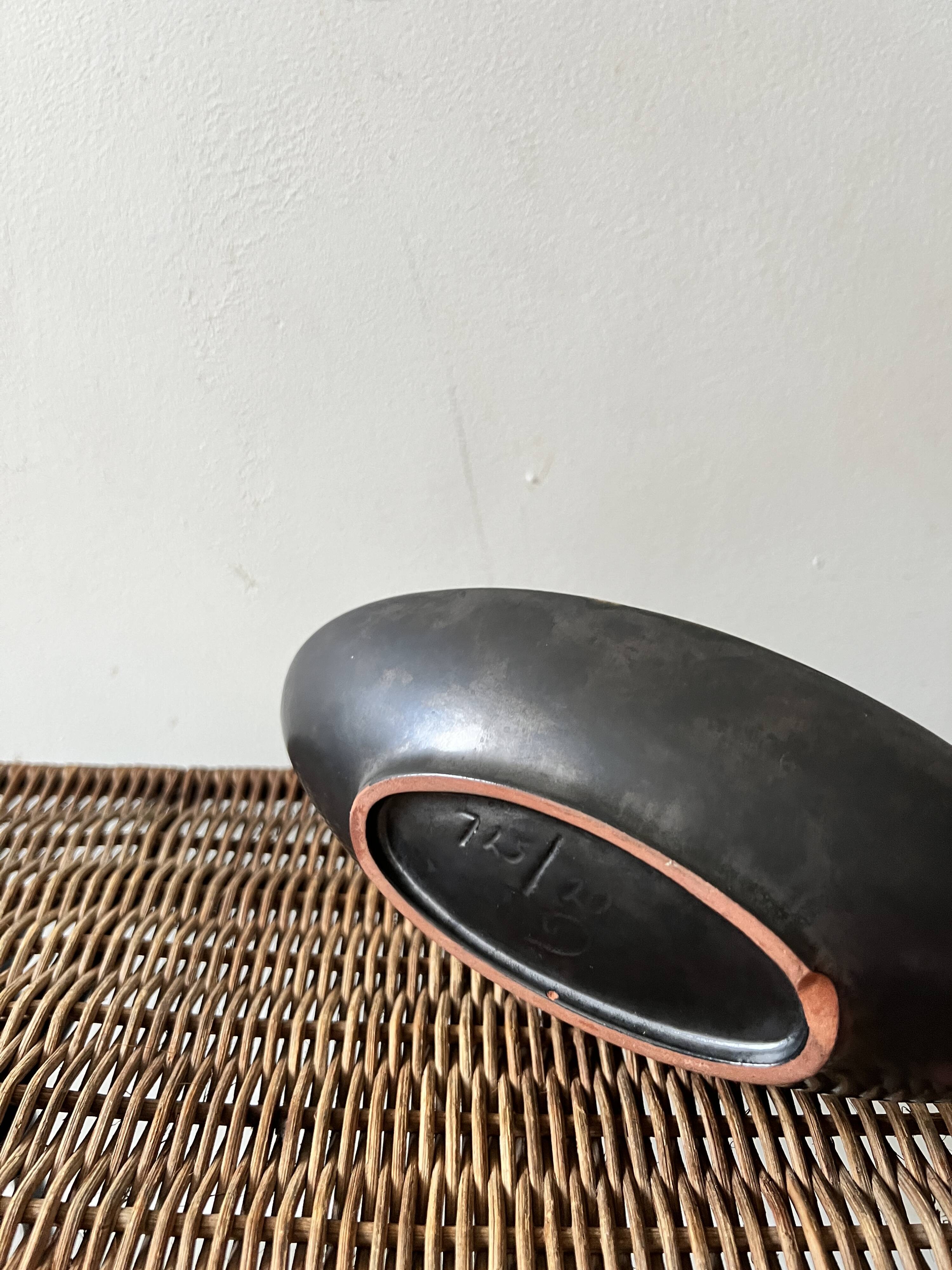 Pale yellow and black ceramic bowl / empty pocket signed by the artist