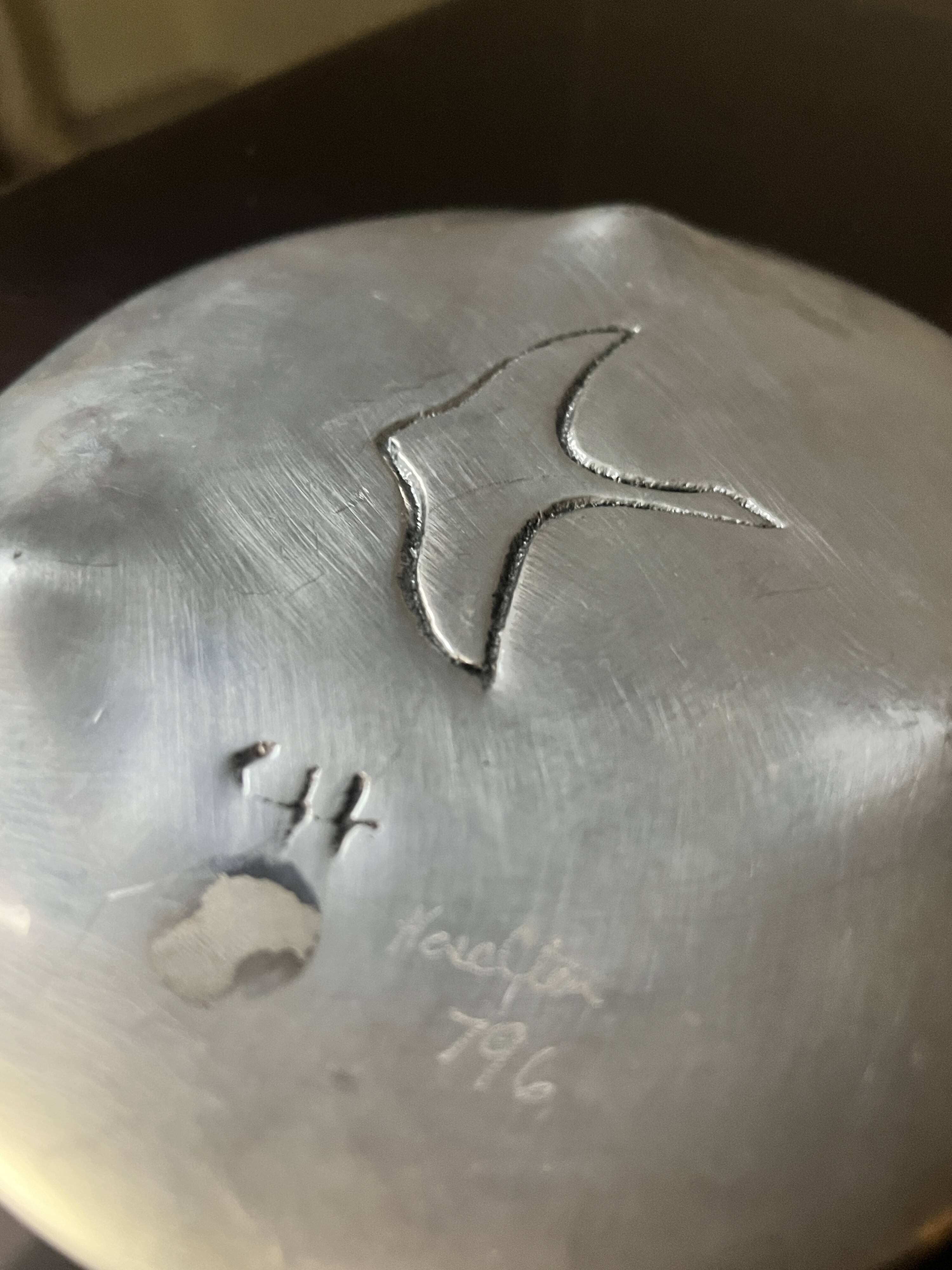 polished aluminum pocket emptier, signed and stamped in the mass