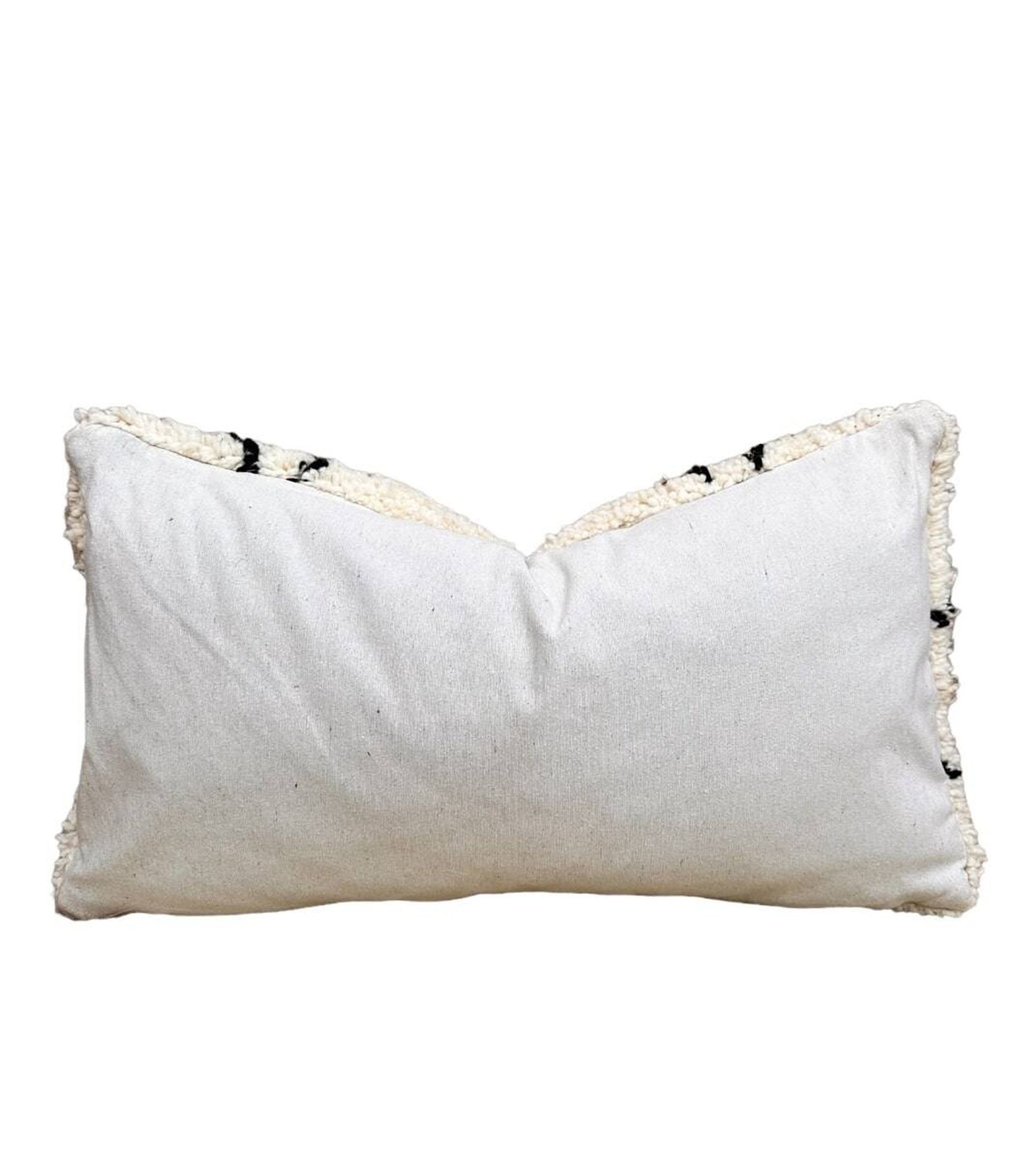 Bohemian wool pillow cover on a Beni Ourain Berber cushion. The cushion cover