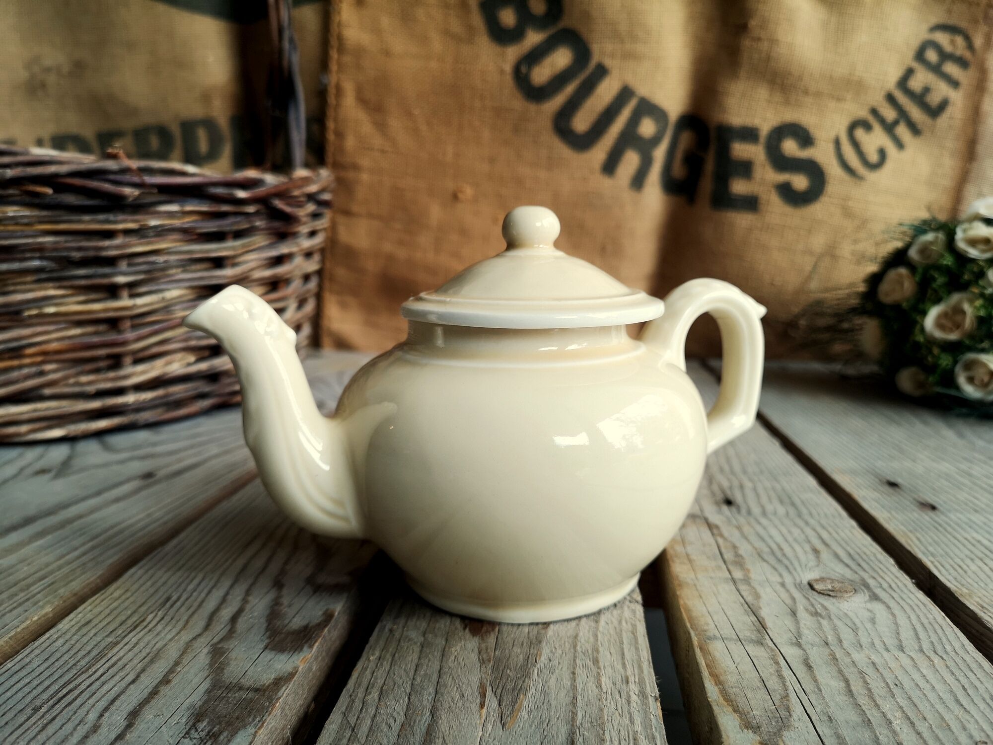 Little ancient teapot in ceramics color cream