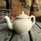 Little ancient teapot in ceramics color cream
