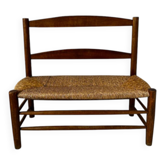 Old wooden and straw bench