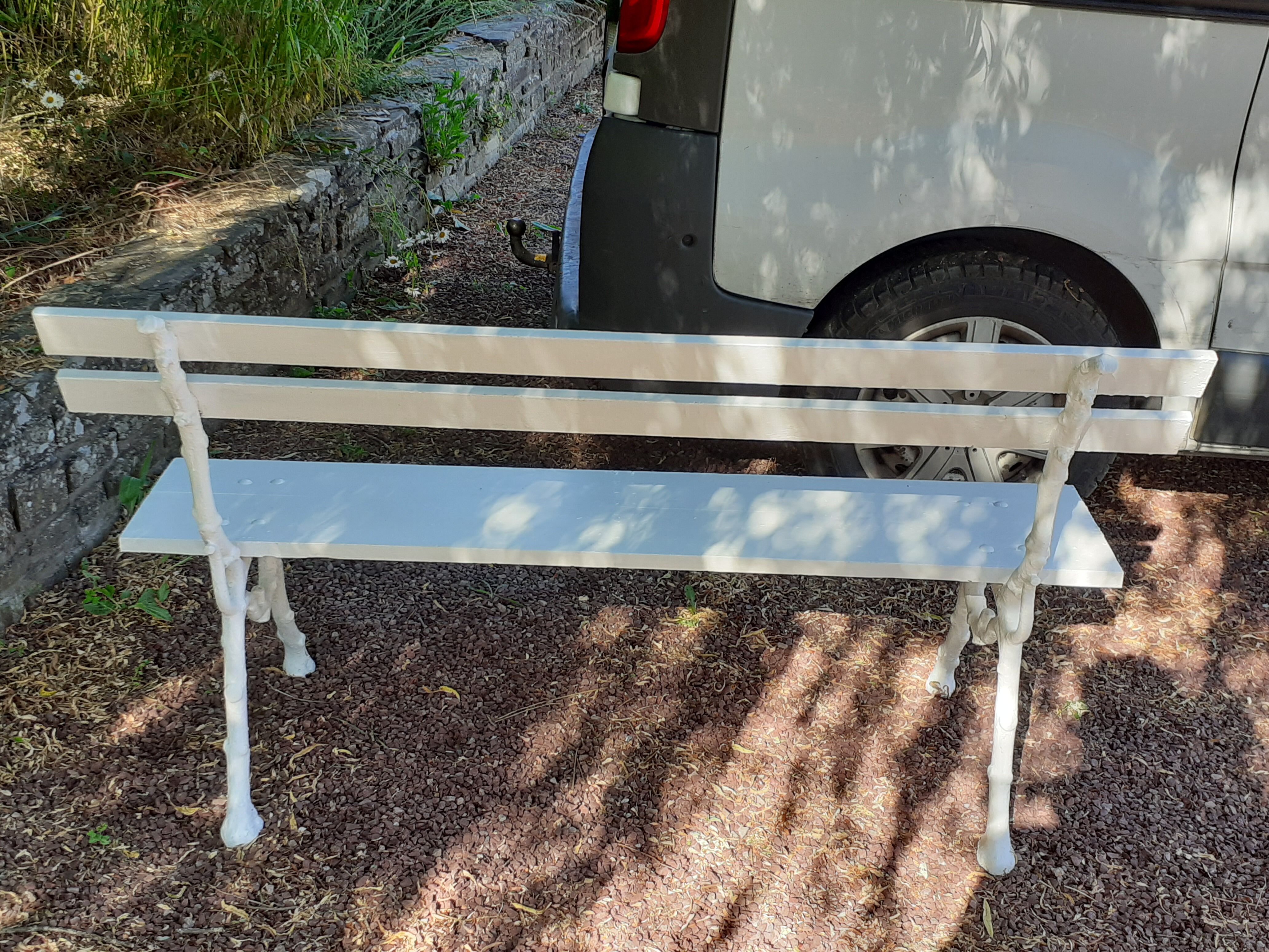 Old garden bench with cast iron feet and wooden planks