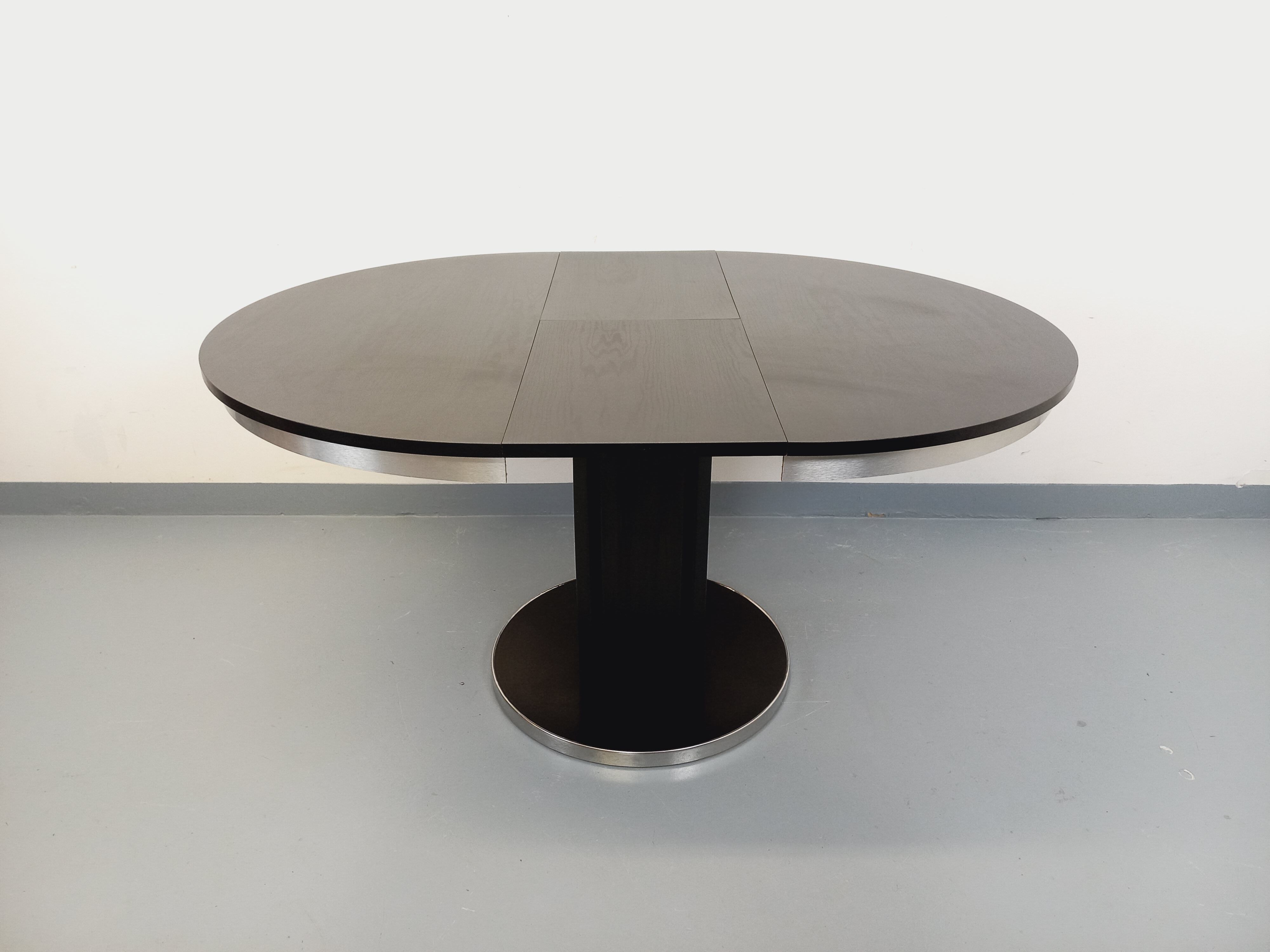 Vintage dining table in melamine with a black wood effect and chrome metal.