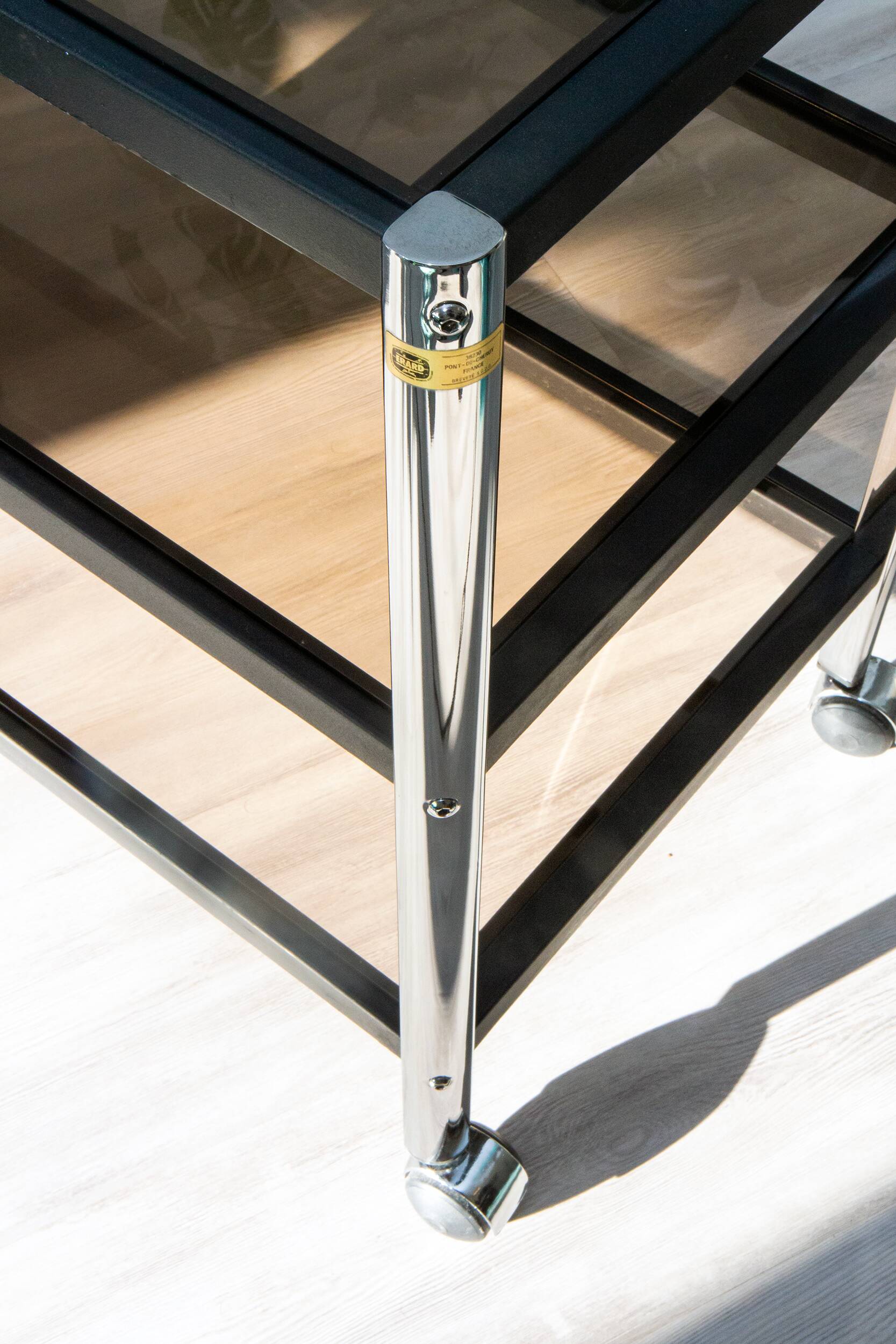 ERARD console (France), black metal and smoked glass side table, 1980.