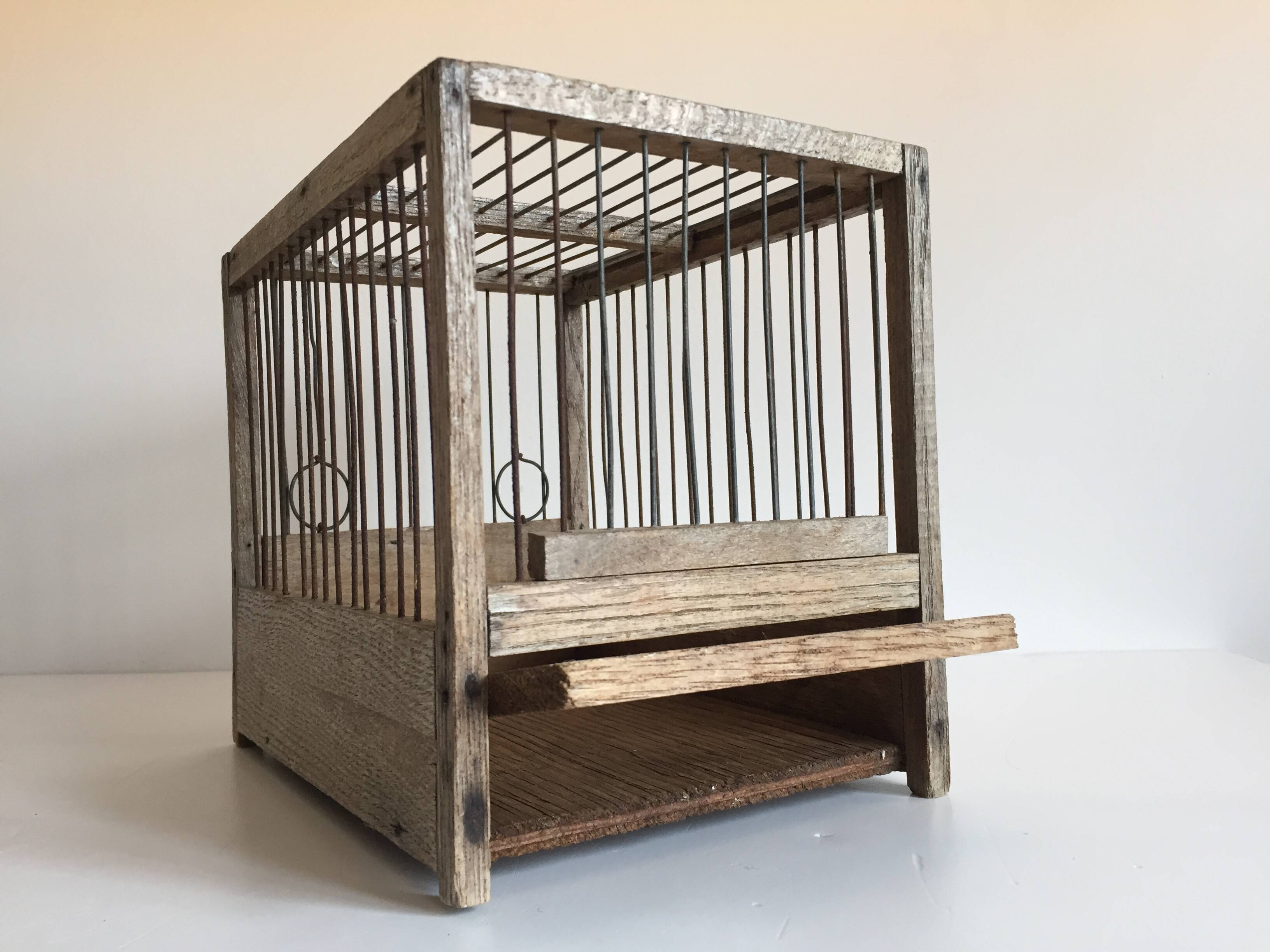 Old bird cage in wood and steel