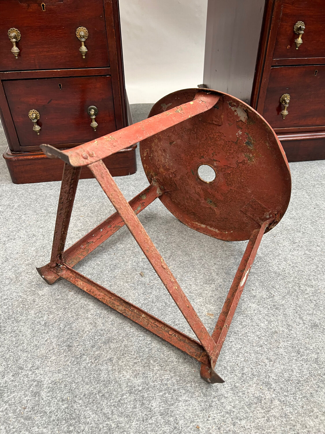 Red tripod industrial metal stool