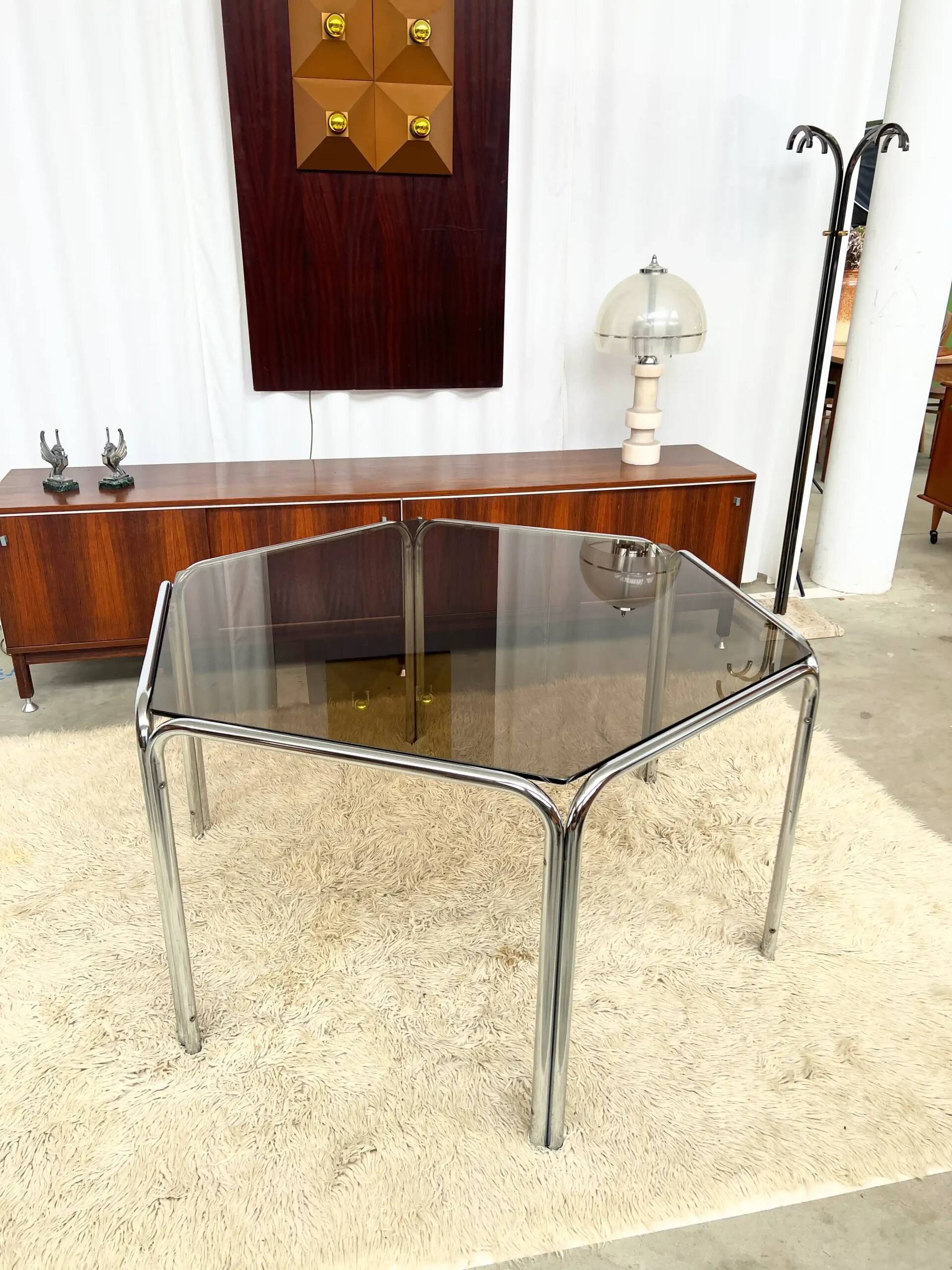 Vintage hexagonal table with smoked glass top and chrome metal structure.