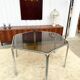 Vintage hexagonal table with smoked glass top and chrome metal structure.