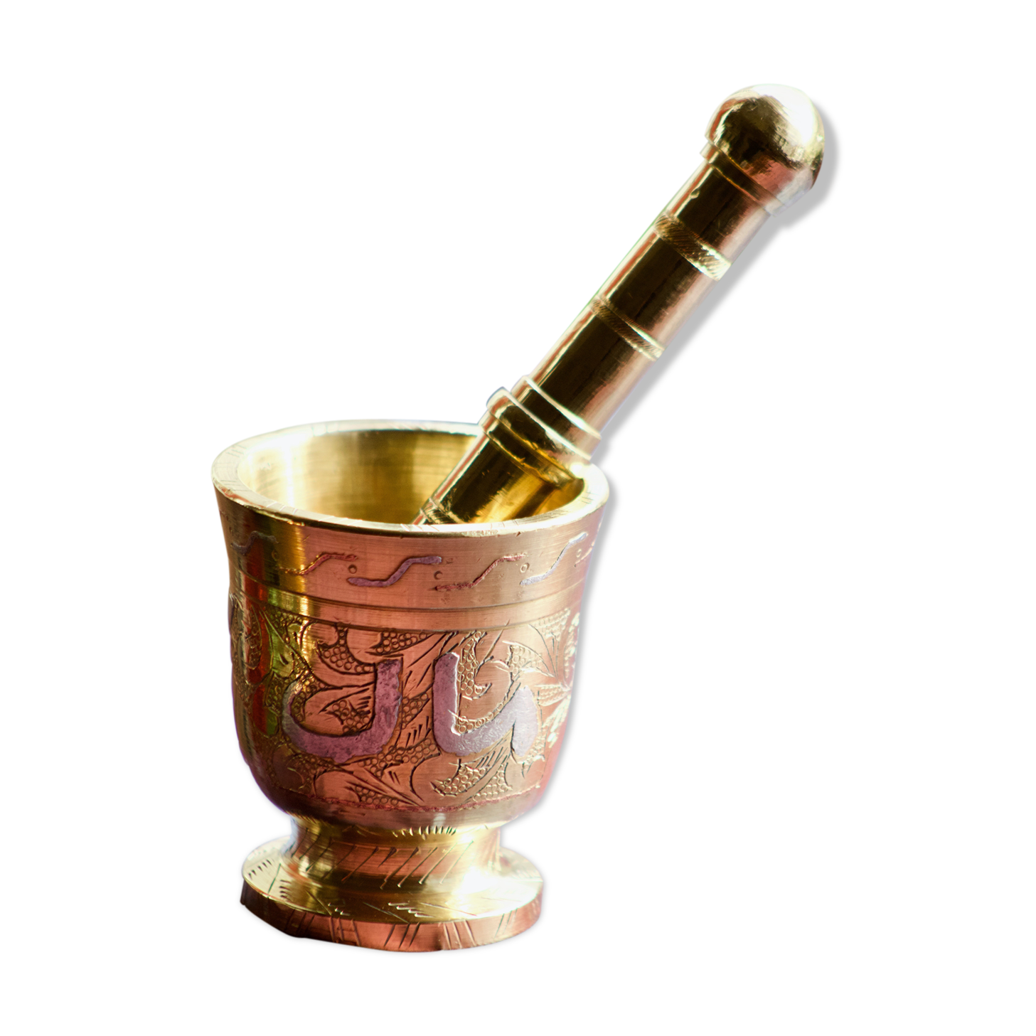 Mortar and its brass pestle with oriental gold and silver motifs