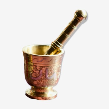 Mortar and its brass pestle with oriental gold and silver motifs