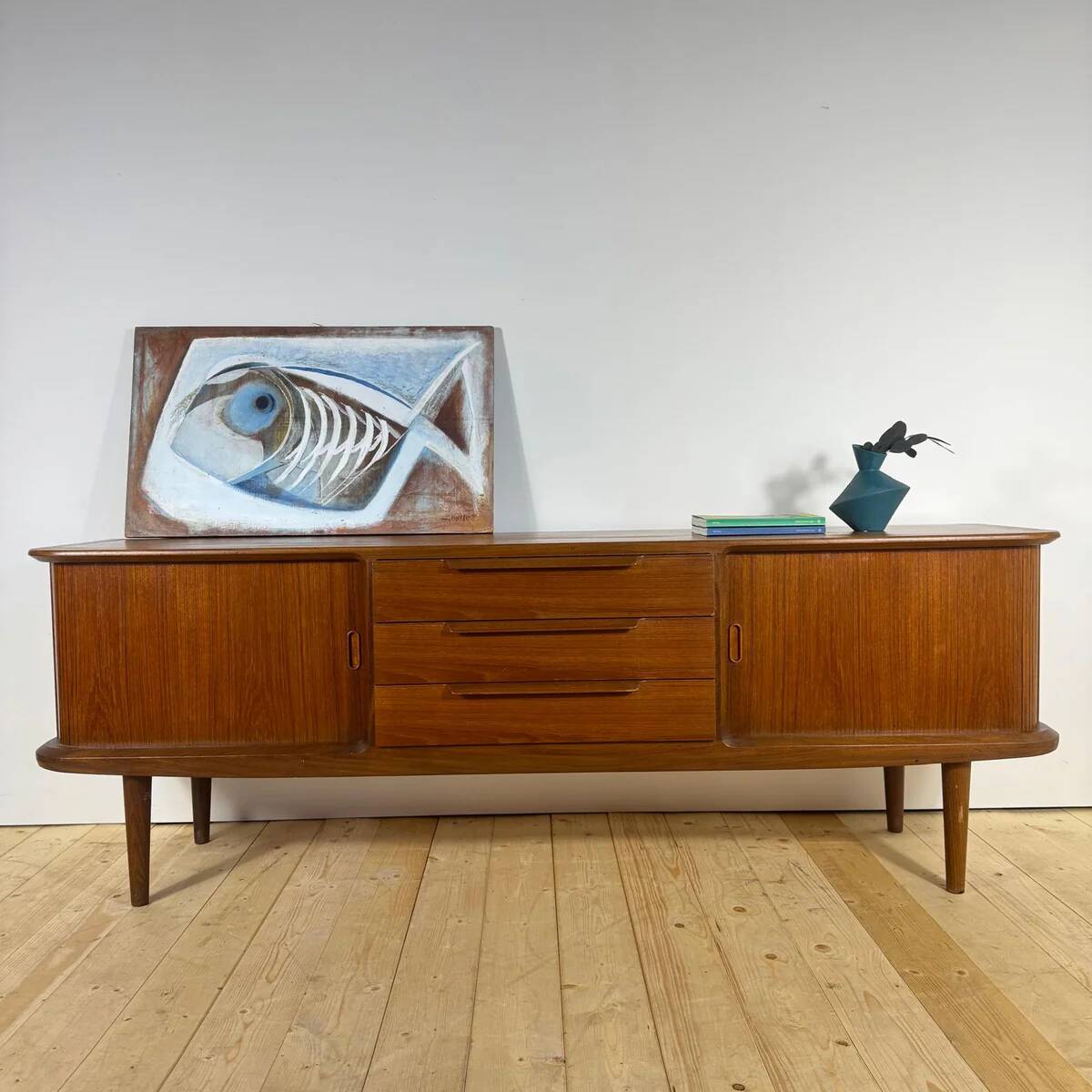 Vintage teak sideboard with rounded edges and sliding doors – mid-century Scandinavian design.