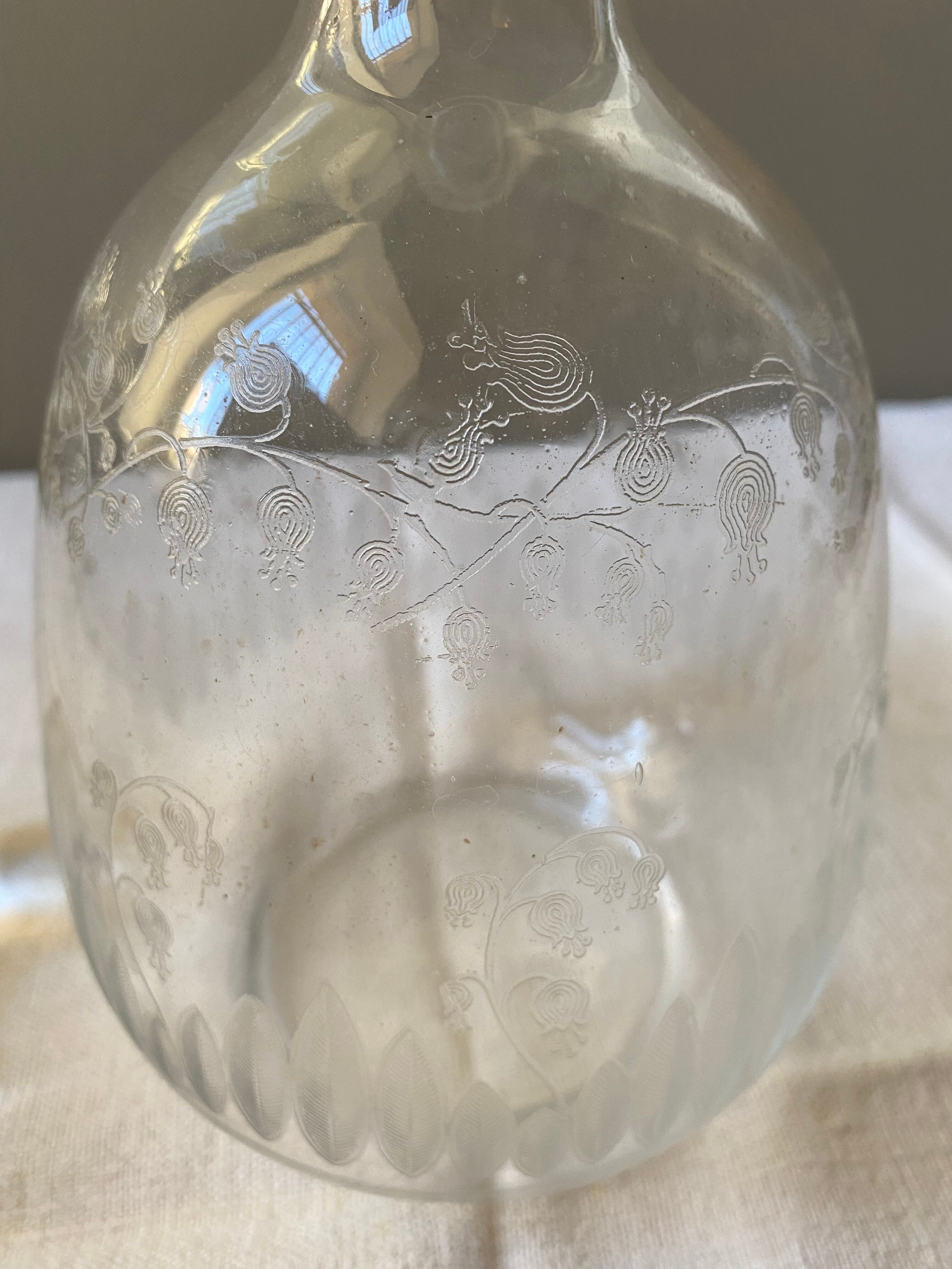 Carved glass decanter with floral decorations