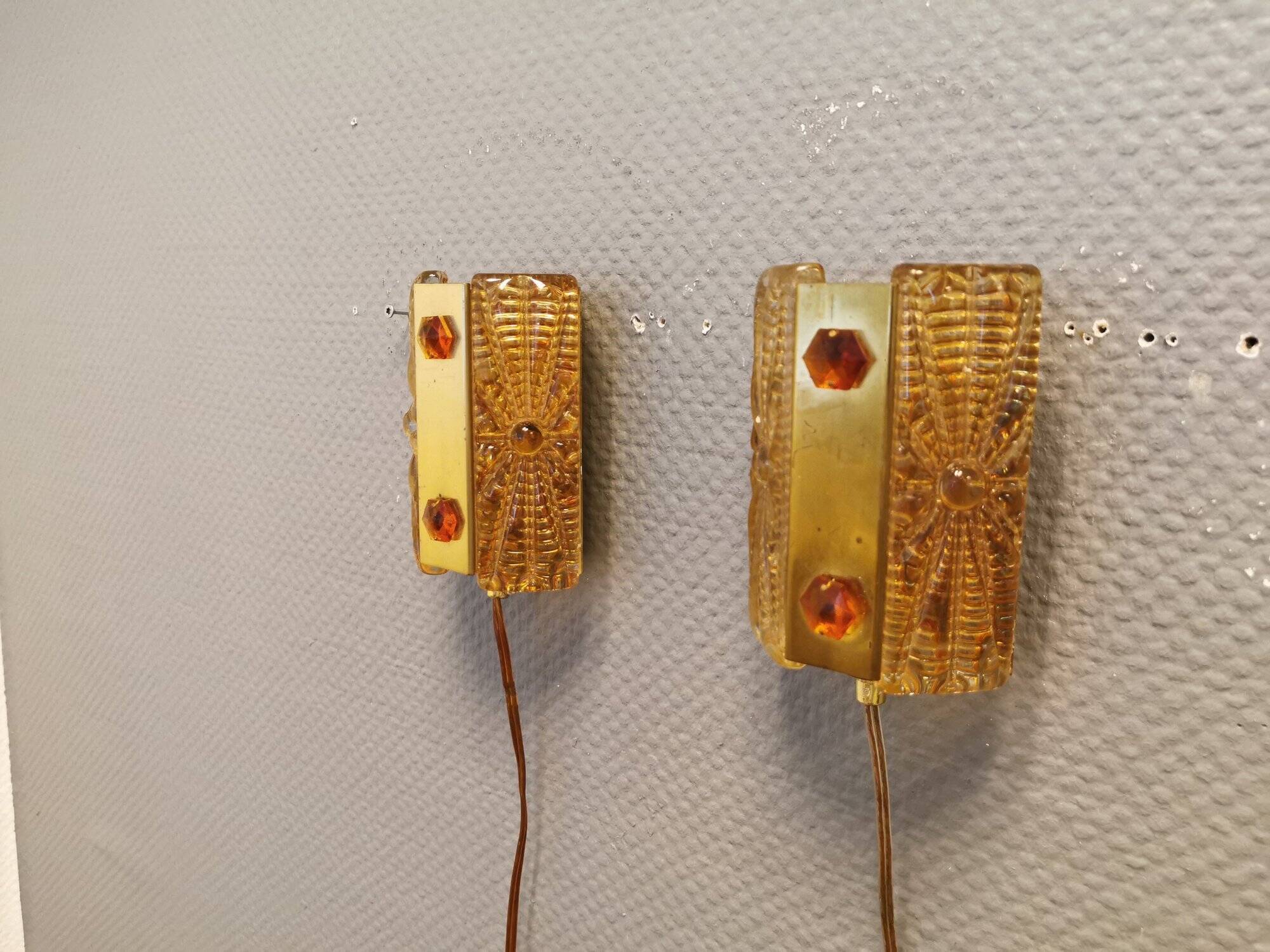 A pair of wall lights with brass-colored suspension with thick pressed glass. Vitrika, Denmark