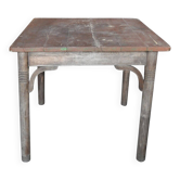 Rustic Thonet table in brown beech, circa 1920, with slatted top and turned legs.