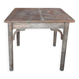 Rustic Thonet table in brown beech, circa 1920, with slatted top and turned legs.
