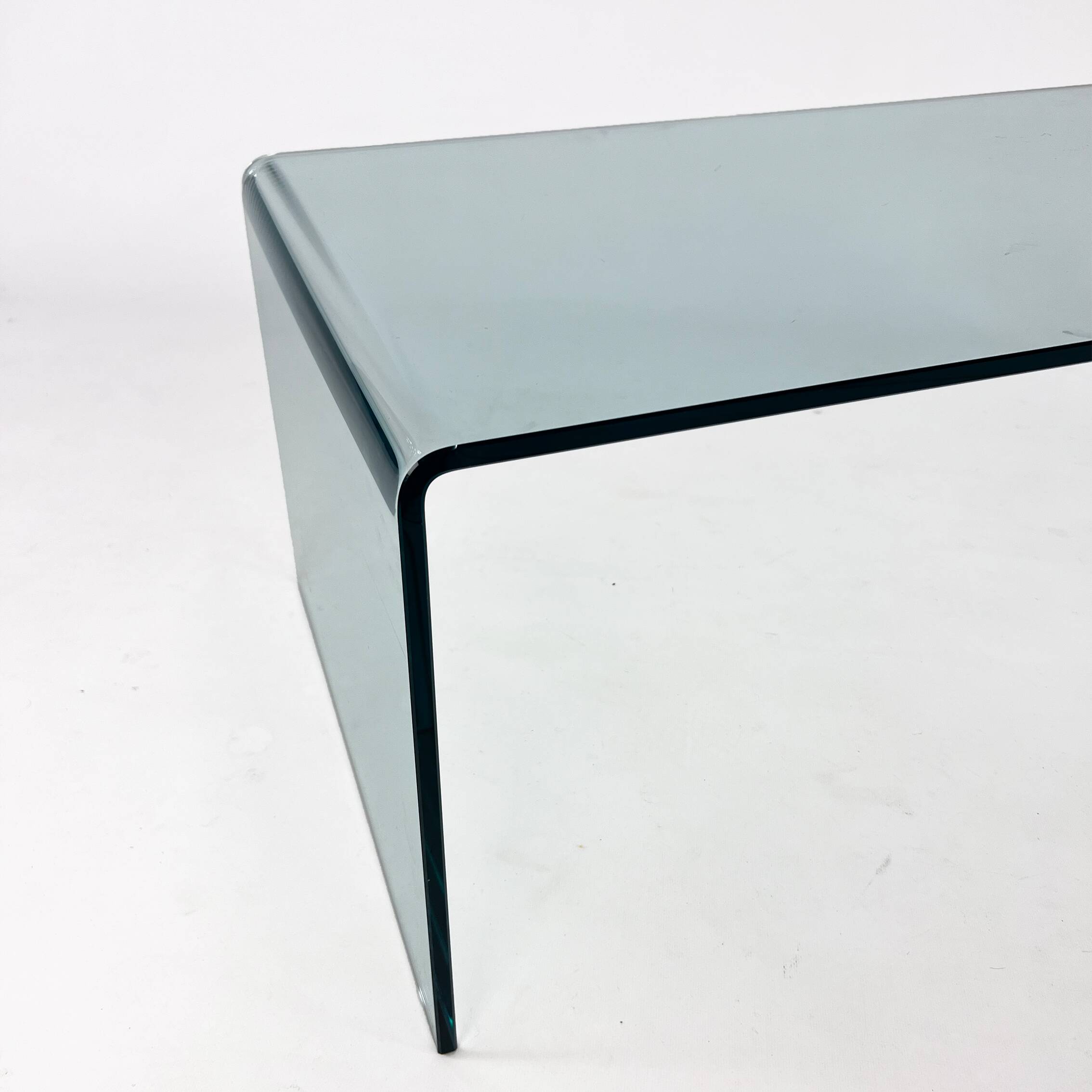 Postmodern coffee table made entirely of glass. Modernist and bitches minimalist look.