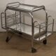 Vintage 1970s rolling dessert trolley in chrome metal and mirrored glass.