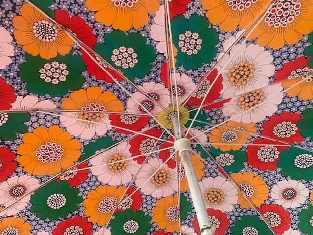 Large floral tilting beach umbrella with cotton fringes, 1960