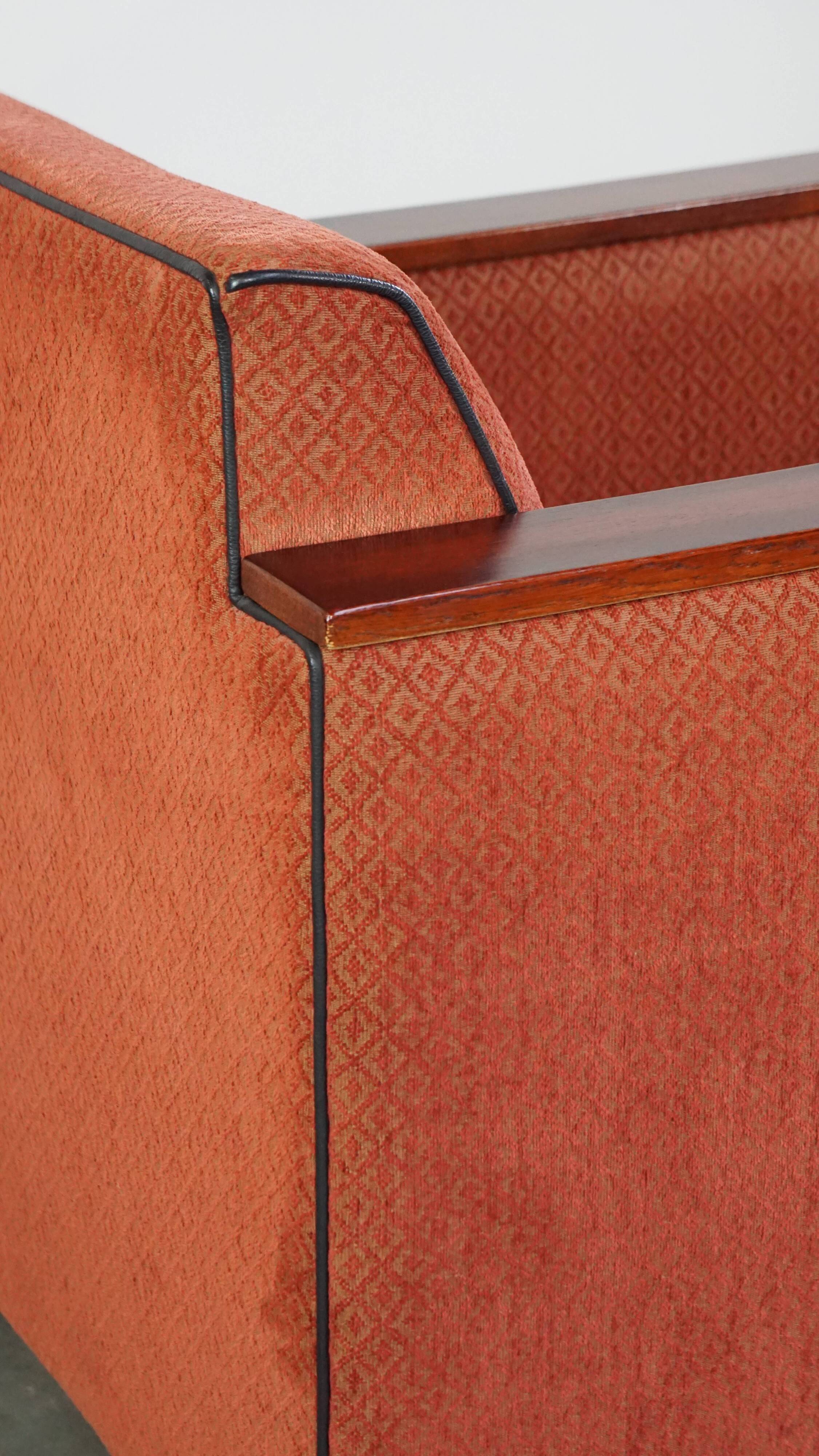 Art Deco design armchair with red fabric upholstery and wooden details