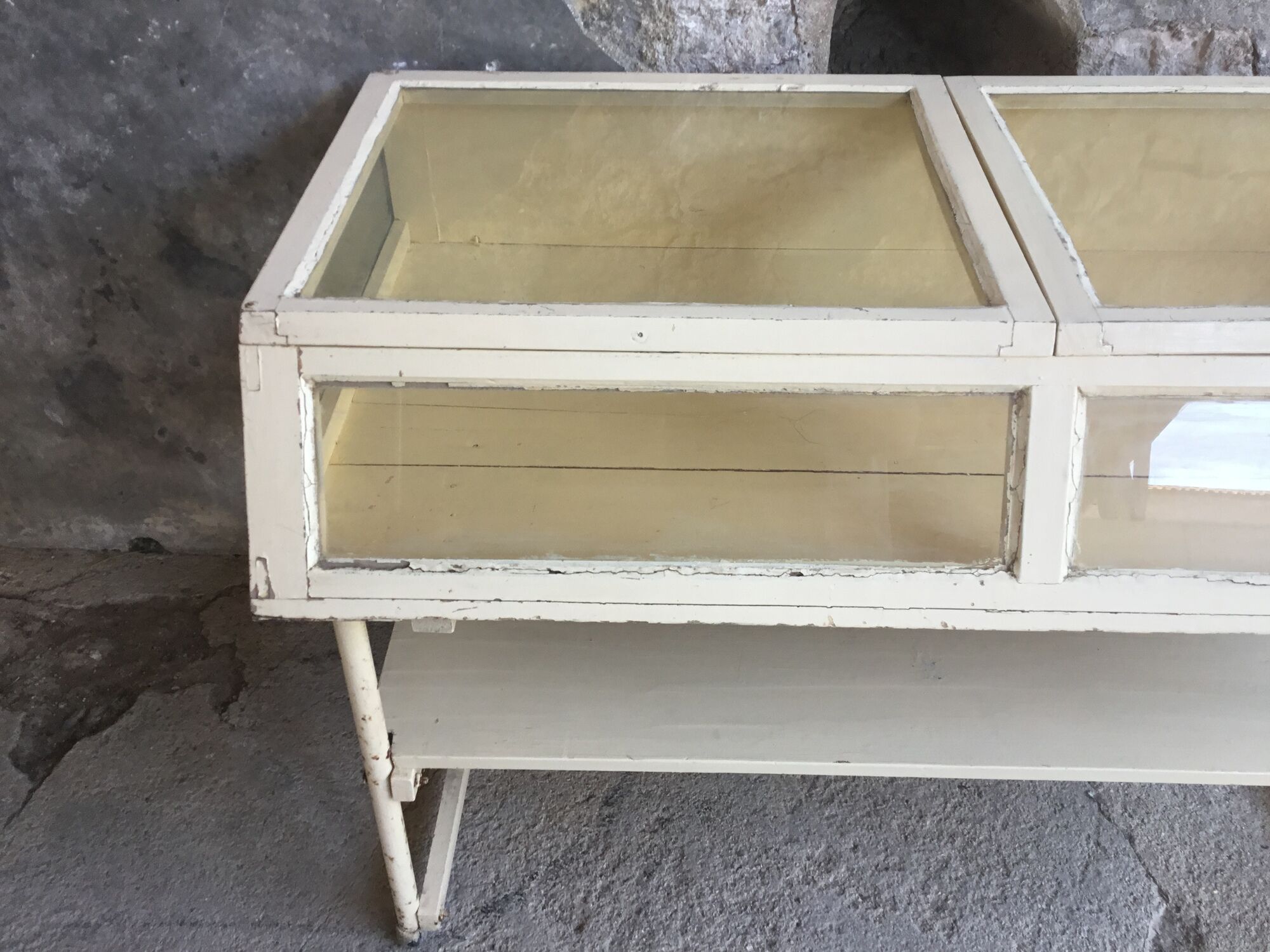 Old showcase on tubular metal feet - early twentieth century