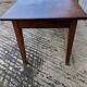 Antique chestnut farmhouse table with 3 drawers on the front.