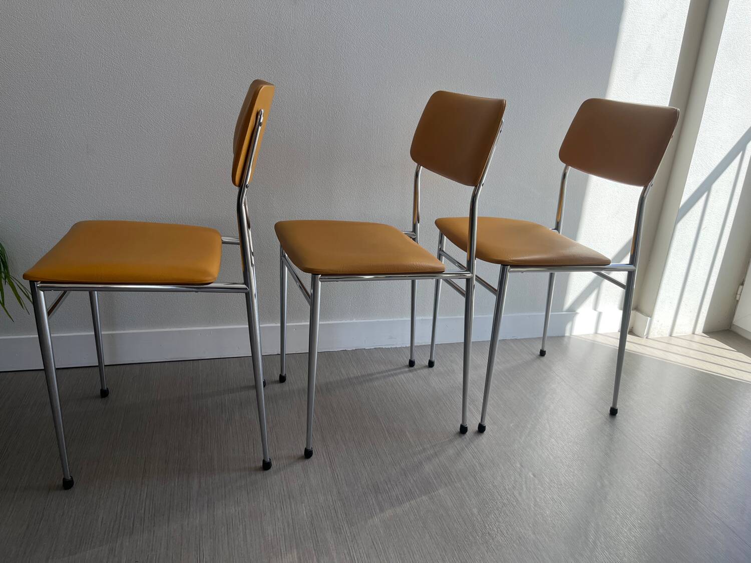 LM vintage chrome and orange/mustard yellow faux leather chairs