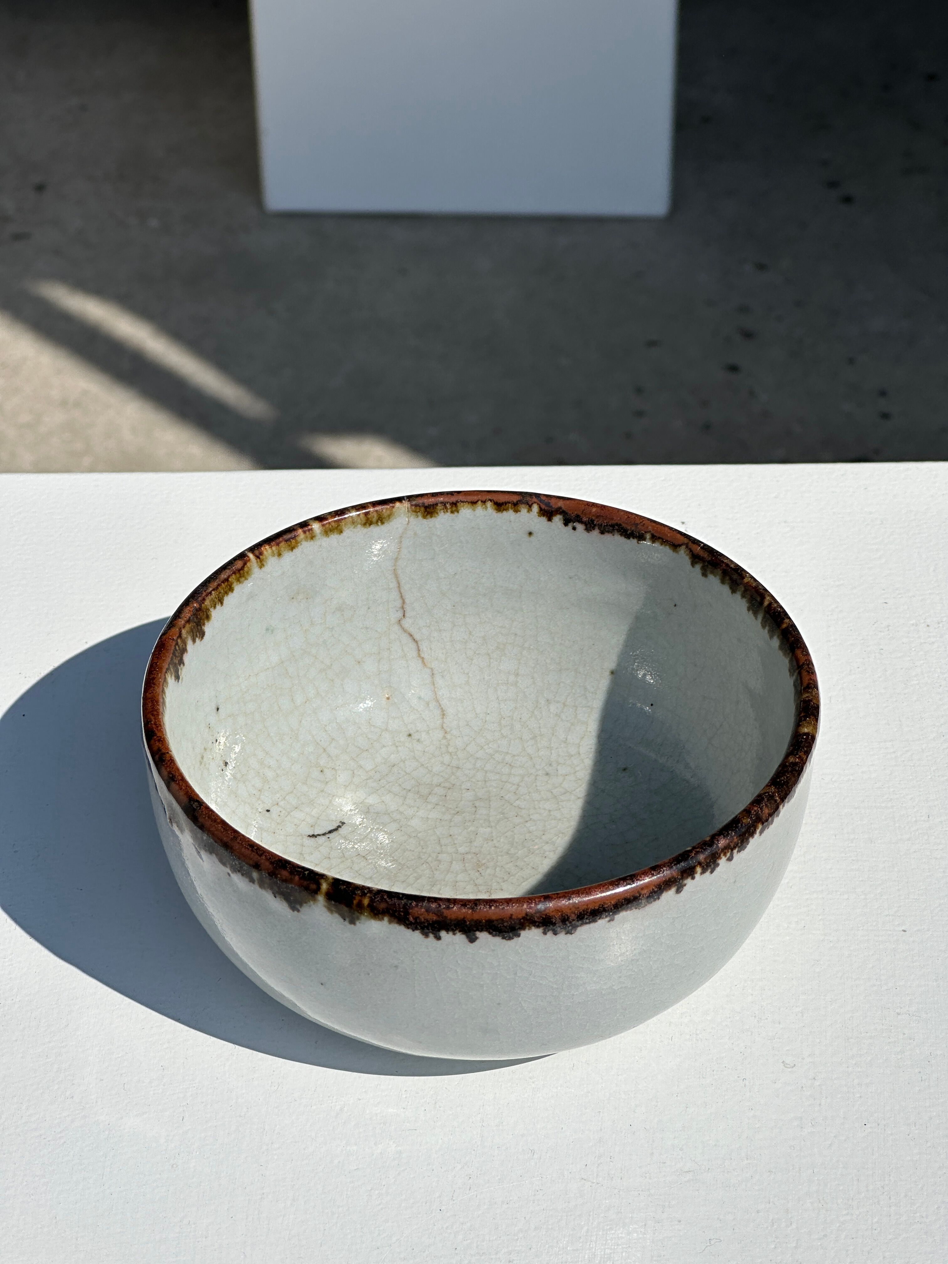 Small white glazed ceramic bowl black edges