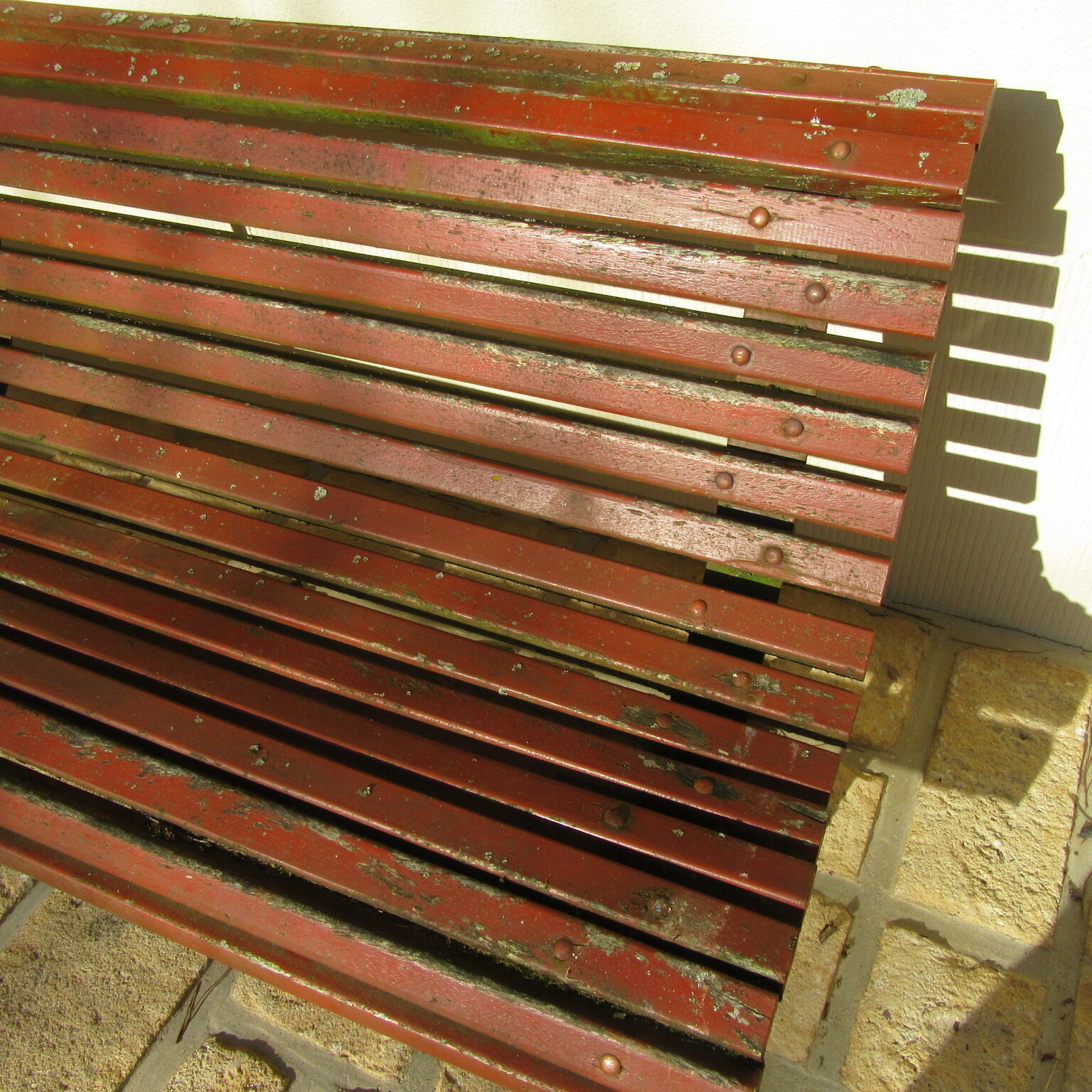 Public bench in wooden slats and cast iron legs