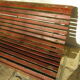 Public bench in wooden slats and cast iron legs